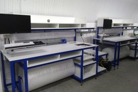 Packing stations with storage shelving