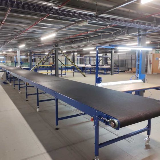 Long belt conveyor for electronics processing