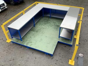 Raised team leader workstation with forklift barriers