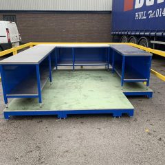 Team leader workstation on a raised platform with yellow safety barrier