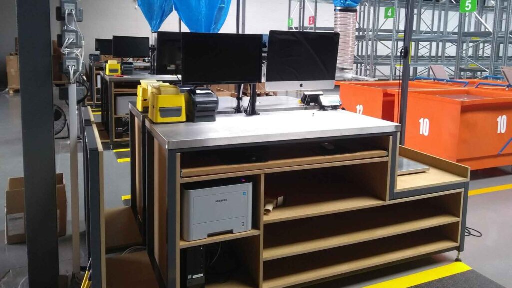 Packing benches with monitors, printers and storage in a warehouse